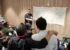 Peserta workshop berdiskusi di depan lembar kerja yang ditempel di dinding